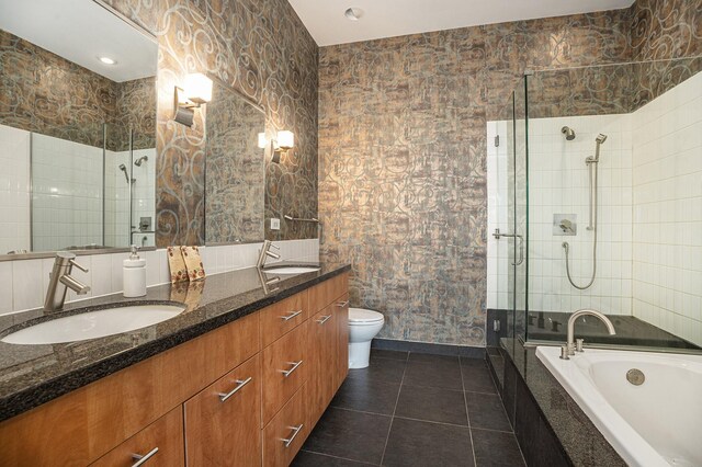 4821 Nasa Pkwy Unit 12E, Pasadena, TX 77586 - full bathroom featuring a stall shower, double vanity, a bath, tile patterned floors, and toilet