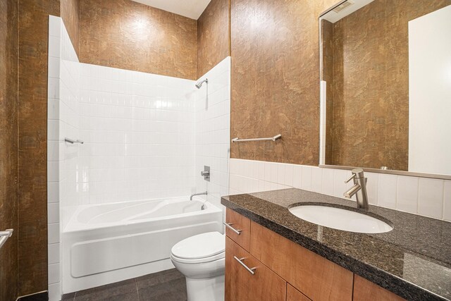 4821 Nasa Pkwy Unit 12E, Pasadena, TX 77586 - full bathroom featuring toilet, vanity, shower / washtub combination, tile walls, and tile patterned floors