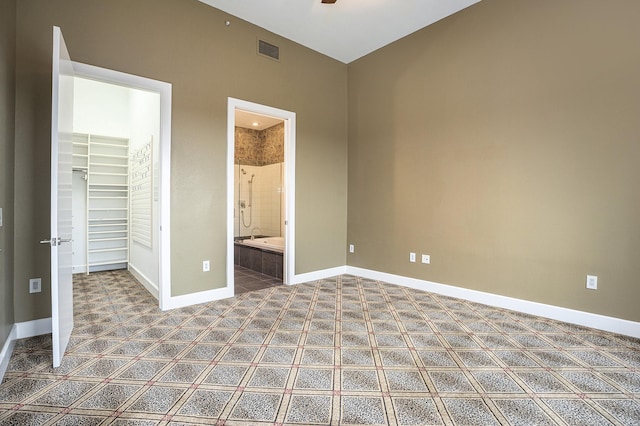 4821 Nasa Pkwy Unit 12E, Pasadena, TX 77586 - unfurnished bedroom with a spacious closet, baseboards, carpet floors, a closet, and connected bathroom