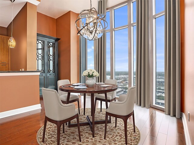 4821 Nasa Pkwy Unit 12E, Pasadena, TX 77586 - dining area featuring light wood finished floors, a chandelier, and baseboards