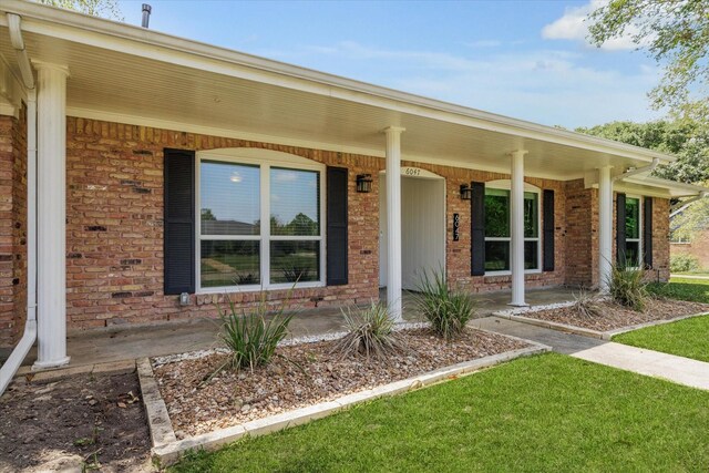 6047 Dumfries Dr, Houston, TX 77096 - doorway to property with a porch and brick siding