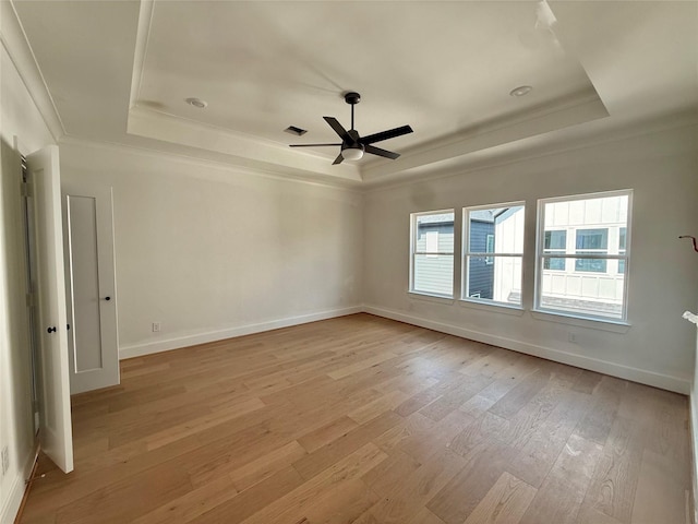 923 Fisher St Unit B, Houston, TX 77018 - empty room featuring a raised ceiling, light wood finished floors, a ceiling fan, crown molding, and baseboards
