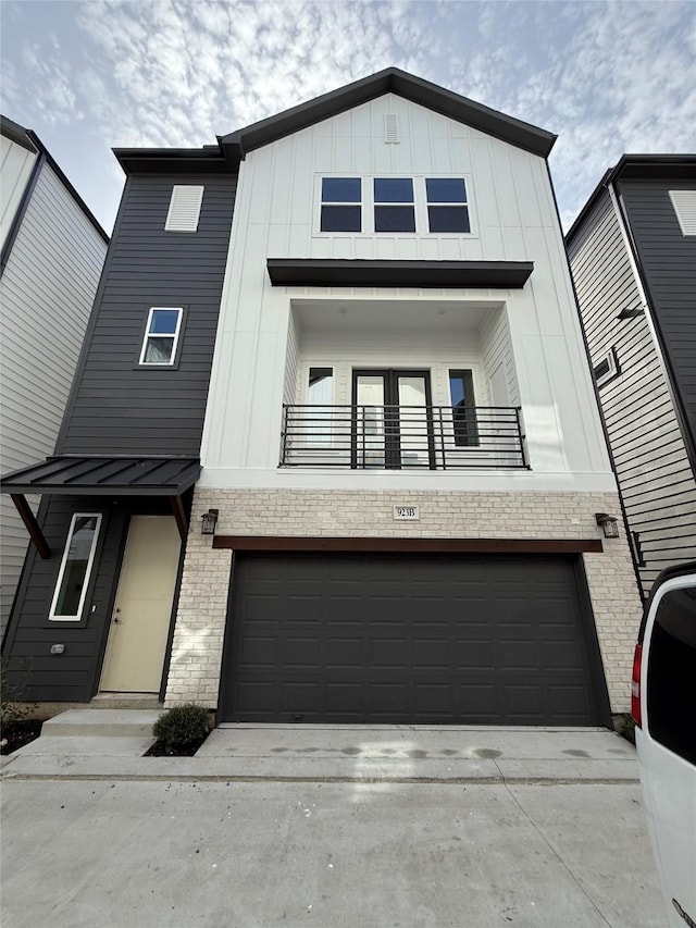 923 Fisher St Unit B, Houston, TX 77018 - view of front of house featuring a balcony, board and batten siding, an attached garage, and concrete driveway