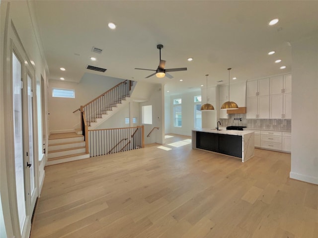 923 Fisher St Unit B, Houston, TX 77018 - kitchen with light countertops, backsplash, healthy amount of natural light, a kitchen island with sink, and recessed lighting