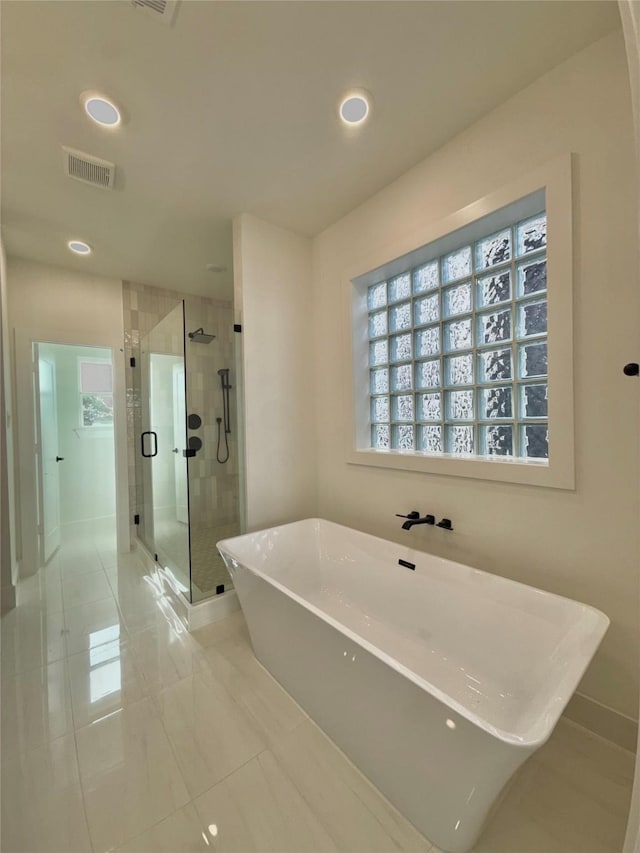 923 Fisher St Unit B, Houston, TX 77018 - full bathroom with a shower stall, a freestanding bath, plenty of natural light, and recessed lighting
