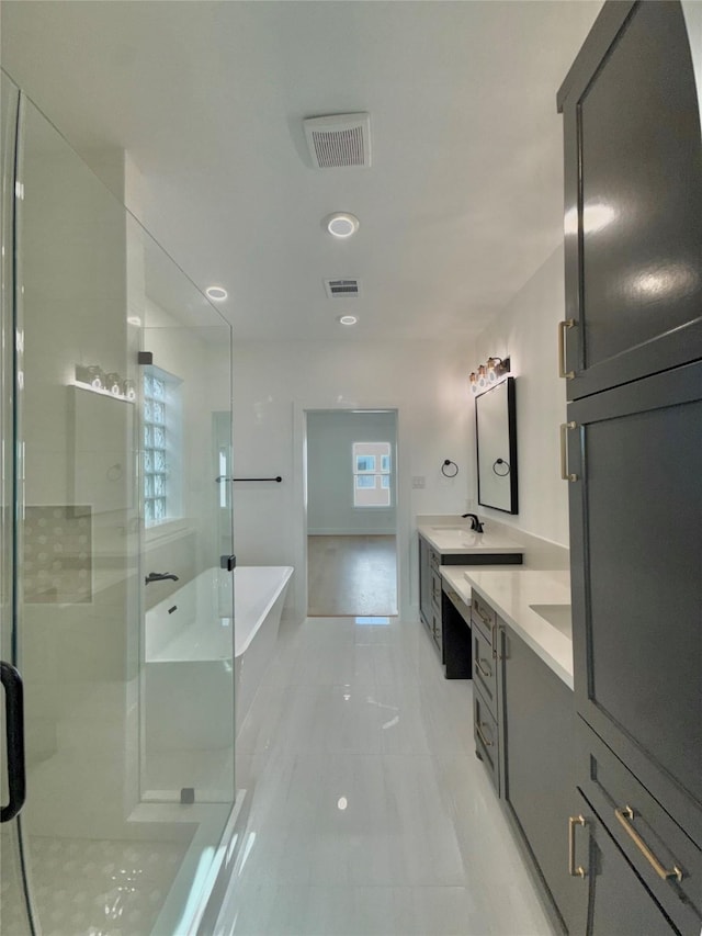 923 Fisher St Unit B, Houston, TX 77018 - bathroom featuring two vanities, a shower stall, a soaking tub, and tile patterned flooring