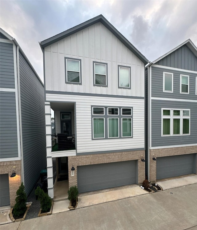 622 Janisch Rd Unit F, Houston, TX 77018 - view of front facade with an attached garage, brick siding, board and batten siding, and driveway