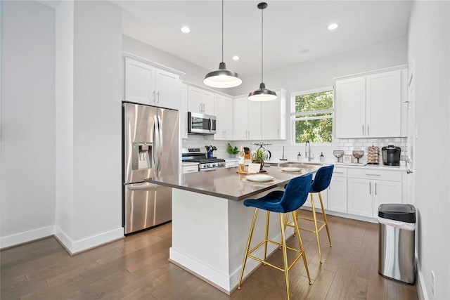 622 Janisch Rd Unit F, Houston, TX 77018 - kitchen with stainless steel appliances, hardwood / wood-style floors, backsplash, white cabinets, and recessed lighting