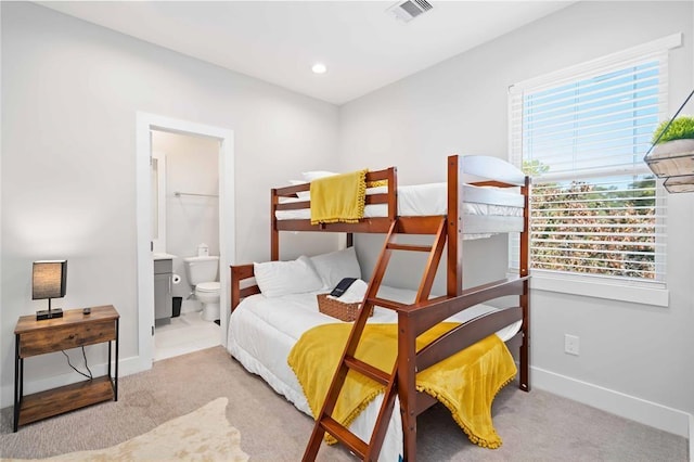 622 Janisch Rd Unit F, Houston, TX 77018 - carpeted bedroom featuring baseboards, connected bathroom, and recessed lighting