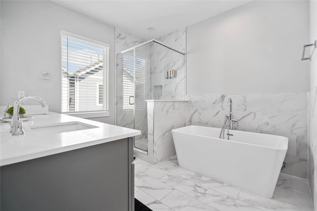 622 Janisch Rd Unit F, Houston, TX 77018 - full bathroom with marble look tile flooring, double vanity, a freestanding tub, a marble finish shower, and tile walls