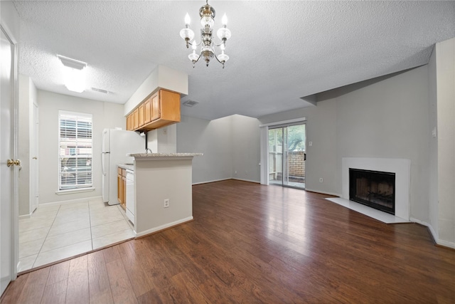 2120 El Paseo St Unit 2901, Houston, TX 77054 - kitchen featuring a textured ceiling, light wood-style flooring, light countertops, a chandelier, and baseboards