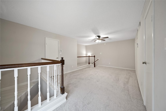 2120 El Paseo St Unit 2901, Houston, TX 77054 - empty room featuring light colored carpet, a ceiling fan, baseboards, and a textured ceiling