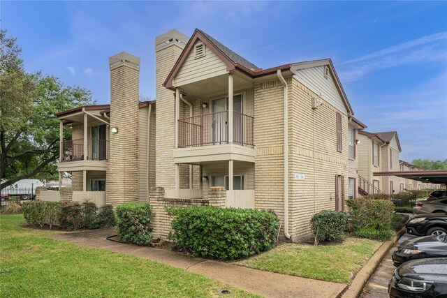 2120 El Paseo St Unit 2901, Houston, TX 77054 - view of side of home featuring a chimney, brick siding, and a balcony