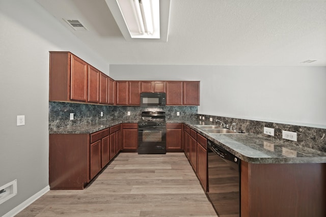 12414 Village Of Kings Lake Blvd, Houston, TX 77044 - kitchen featuring black appliances, dark countertops, decorative backsplash, and light wood-style floors