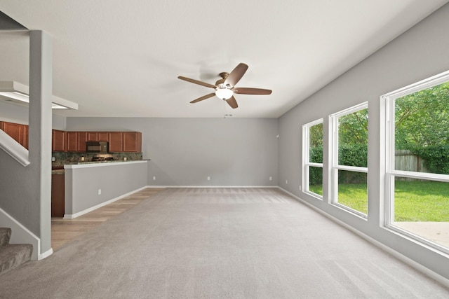 12414 Village Of Kings Lake Blvd, Houston, TX 77044 - unfurnished living room with light carpet, a ceiling fan, baseboards, and stairway