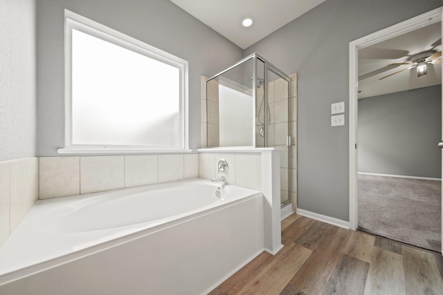 12414 Village Of Kings Lake Blvd, Houston, TX 77044 - full bath featuring a bath, a shower stall, a ceiling fan, and wood finished floors