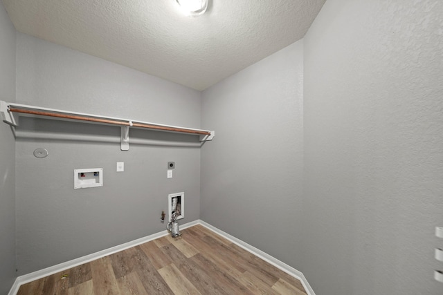 12414 Village Of Kings Lake Blvd, Houston, TX 77044 - laundry room featuring hookup for a gas dryer, hookup for an electric dryer, wood finished floors, washer hookup, and baseboards