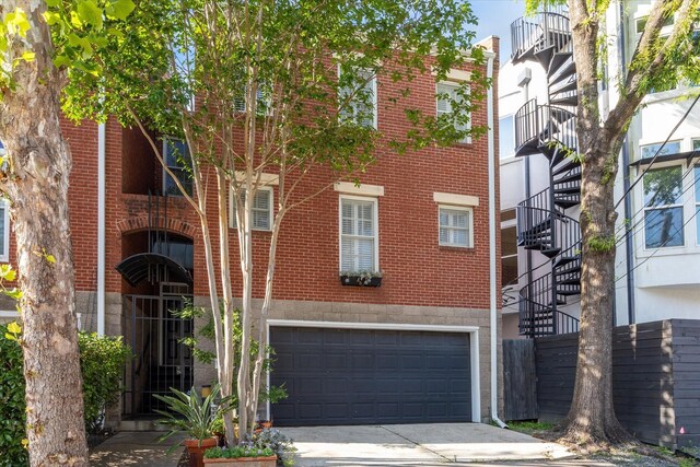1984 Indiana St, Houston, TX 77019 - view of building exterior featuring stairs, an attached garage, and driveway