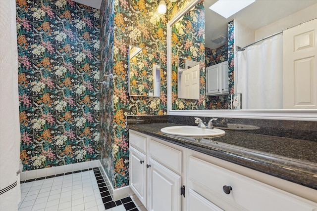 1984 Indiana St, Houston, TX 77019 - full bathroom featuring wallpapered walls, tile patterned floors, vanity, a skylight, and baseboards
