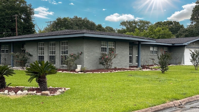 4400 Bethany St, Port Arthur, TX 77642 - view of front of property featuring a front lawn, brick siding, and a garage