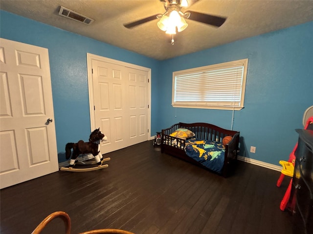 4400 Bethany St, Port Arthur, TX 77642 - bedroom with wood finished floors, baseboards, a textured ceiling, and a ceiling fan