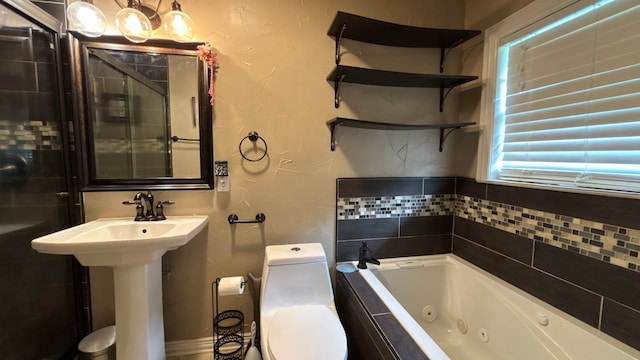 4400 Bethany St, Port Arthur, TX 77642 - full bath with a whirlpool tub, toilet, a textured wall, and a sink