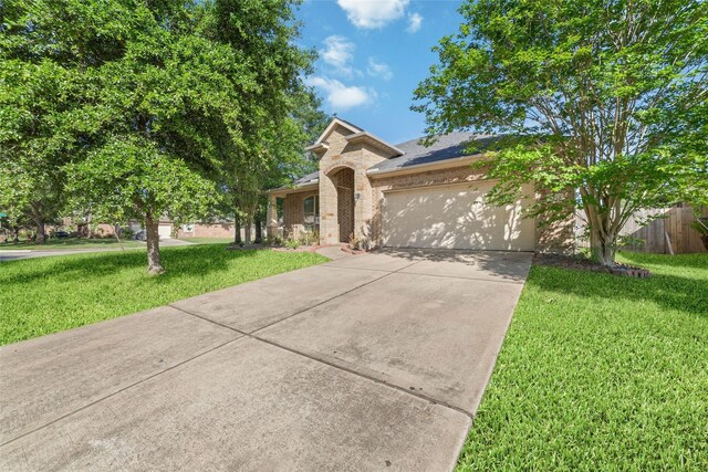6230 Borg Breakpoint Dr, Spring, TX 77379 - view of front of home featuring an attached garage, concrete driveway, brick siding, and a shingled roof