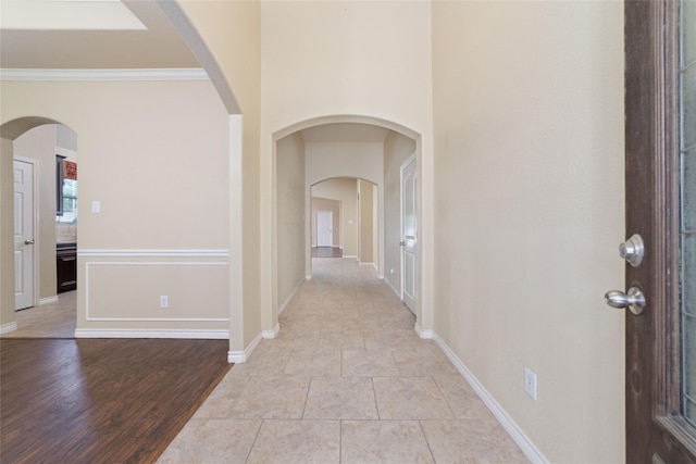 6230 Borg Breakpoint Dr, Spring, TX 77379 - foyer with ornamental molding, baseboards, light wood finished floors, and arched walkways