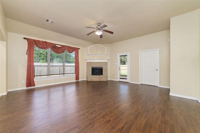 6230 Borg Breakpoint Dr, Spring, TX 77379 - unfurnished living room featuring a ceiling fan, dark wood finished floors, a stone fireplace, and healthy amount of natural light