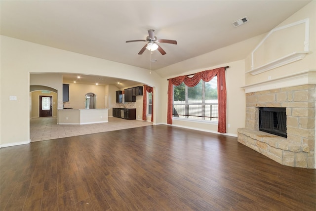 6230 Borg Breakpoint Dr, Spring, TX 77379 - unfurnished living room featuring arched walkways, light wood-style floors, ceiling fan, and lofted ceiling