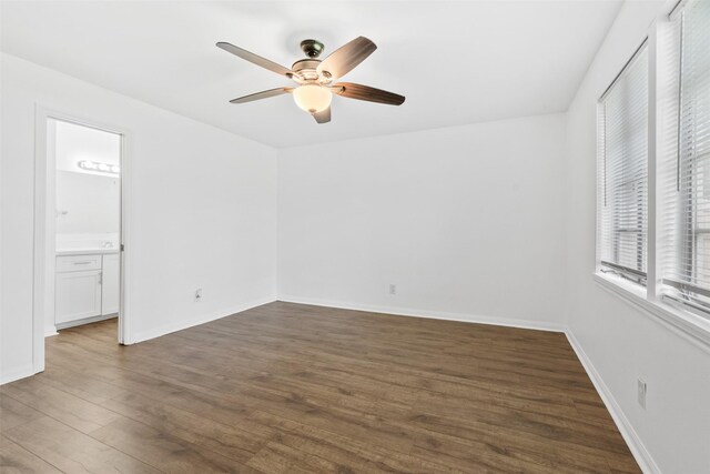710 Vashti Dr, Houston, TX 77037 - spare room with a ceiling fan, dark wood-style floors, and baseboards
