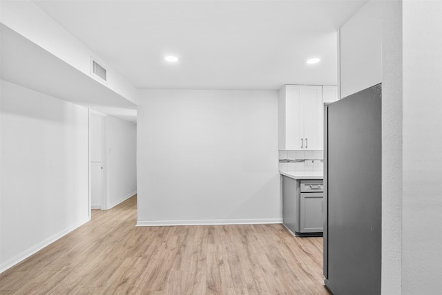 710 Vashti Dr, Houston, TX 77037 - kitchen featuring freestanding refrigerator, light wood-style flooring, light countertops, recessed lighting, and baseboards