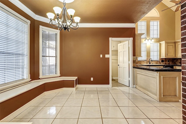 5802 Ashmere Ln, Spring, TX 77379 - unfurnished dining area with a chandelier, light tile patterned floors, ornamental molding, baseboards, and a sink
