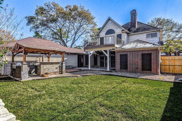 5802 Ashmere Ln, Spring, TX 77379 - back of house with a balcony, a patio area, brick siding, a gazebo, and a chimney