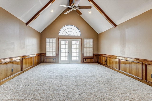 5802 Ashmere Ln, Spring, TX 77379 - spare room with high vaulted ceiling, beam ceiling, wainscoting, a ceiling fan, and light carpet