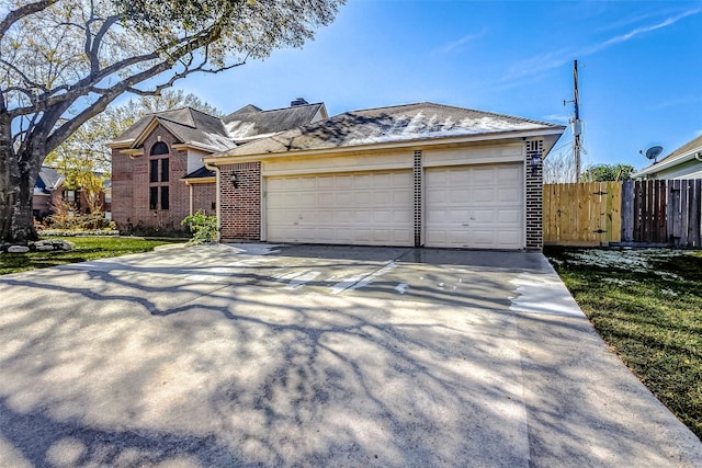 5802 Ashmere Ln, Spring, TX 77379 - view of front of home featuring brick siding, driveway, an attached garage, and a chimney
