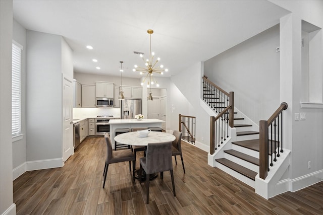 5405 Larkin St, Houston, TX 77007 - dining area with wood finished floors, stairway, baseboards, a chandelier, and recessed lighting