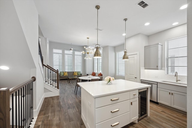 5405 Larkin St, Houston, TX 77007 - kitchen with a sink, beverage cooler, dishwasher, dark wood-style flooring, and light countertops