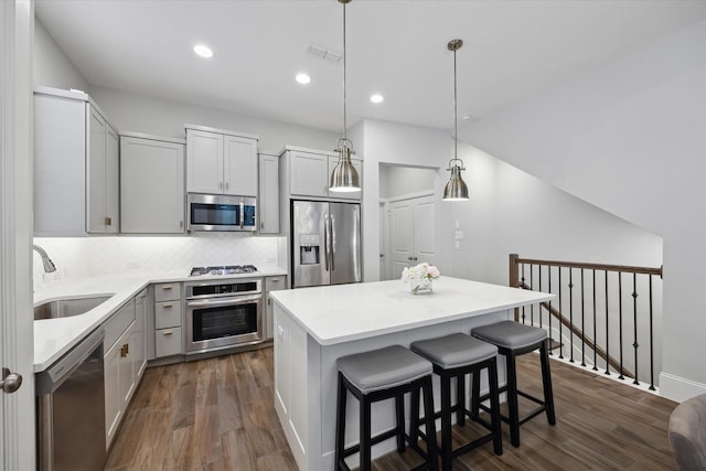 5405 Larkin St, Houston, TX 77007 - kitchen with stainless steel appliances, a sink, a center island, tasteful backsplash, and light countertops