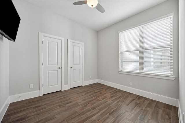 5405 Larkin St, Houston, TX 77007 - unfurnished bedroom featuring dark wood-style floors, baseboards, and a ceiling fan