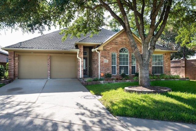 10906 Bernalda Cir, Richmond, TX 77406 - view of front of property with an attached garage, concrete driveway, brick siding, a front lawn, and roof with shingles