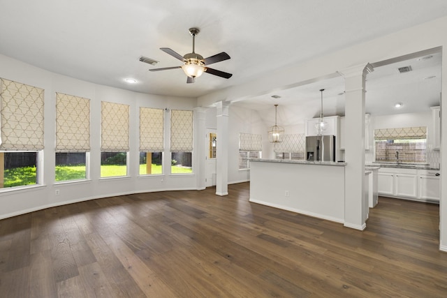 10906 Bernalda Cir, Richmond, TX 77406 - unfurnished living room featuring decorative columns, a ceiling fan, dark wood finished floors, baseboards, and recessed lighting