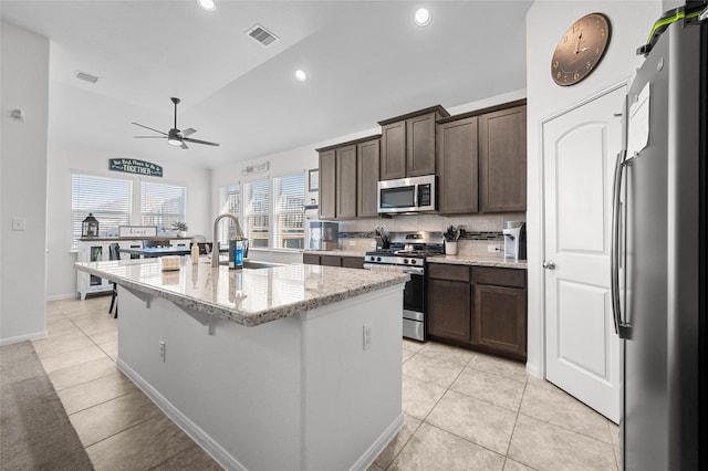 123 San Gabriel Dr, Baytown, TX 77523 - kitchen with appliances with stainless steel finishes, a sink, a ceiling fan, dark brown cabinetry, and recessed lighting