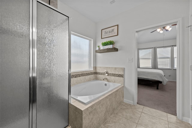 123 San Gabriel Dr, Baytown, TX 77523 - ensuite bathroom featuring a stall shower, a bath, ceiling fan, tile patterned floors, and baseboards