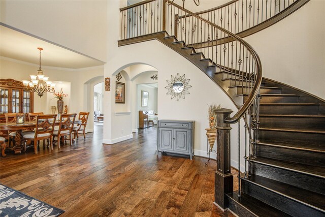 2515 Rainflower Meadow Ln, Katy, TX 77494 - foyer entrance featuring arched walkways, wood finished floors, stairs, a chandelier, and crown molding