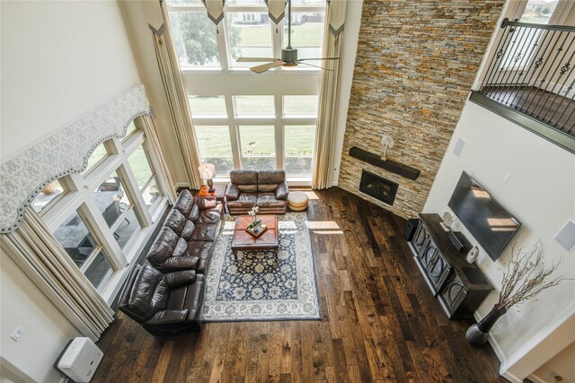 2515 Rainflower Meadow Ln, Katy, TX 77494 - living area featuring a high ceiling, a ceiling fan, wood-type flooring, and a fireplace