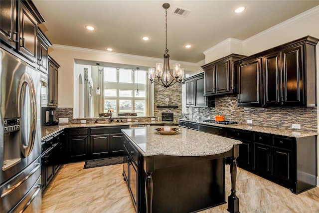 2515 Rainflower Meadow Ln, Katy, TX 77494 - kitchen featuring stainless steel appliances, a sink, backsplash, crown molding, and a chandelier