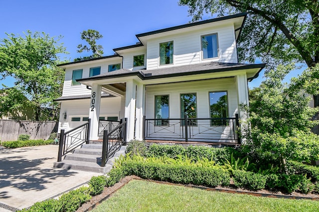 802 W 30th St, Houston, TX 77018 - view of front of home featuring concrete driveway, a garage, and a porch
