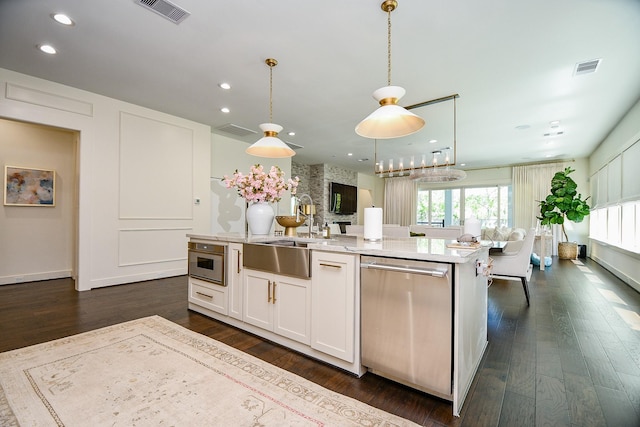 802 W 30th St, Houston, TX 77018 - kitchen with appliances with stainless steel finishes, a sink, a kitchen island with sink, white cabinets, and dark wood-style flooring