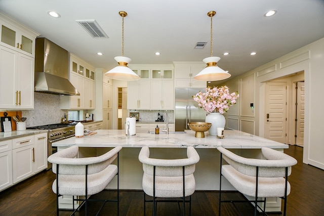 802 W 30th St, Houston, TX 77018 - kitchen featuring wall chimney exhaust hood, premium appliances, backsplash, recessed lighting, and hanging light fixtures
